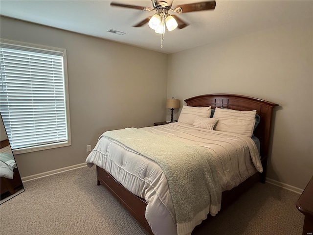 bedroom with carpet floors, visible vents, baseboards, and a ceiling fan