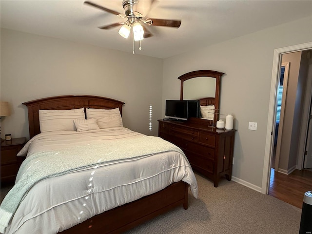 bedroom with ceiling fan, carpet flooring, and baseboards