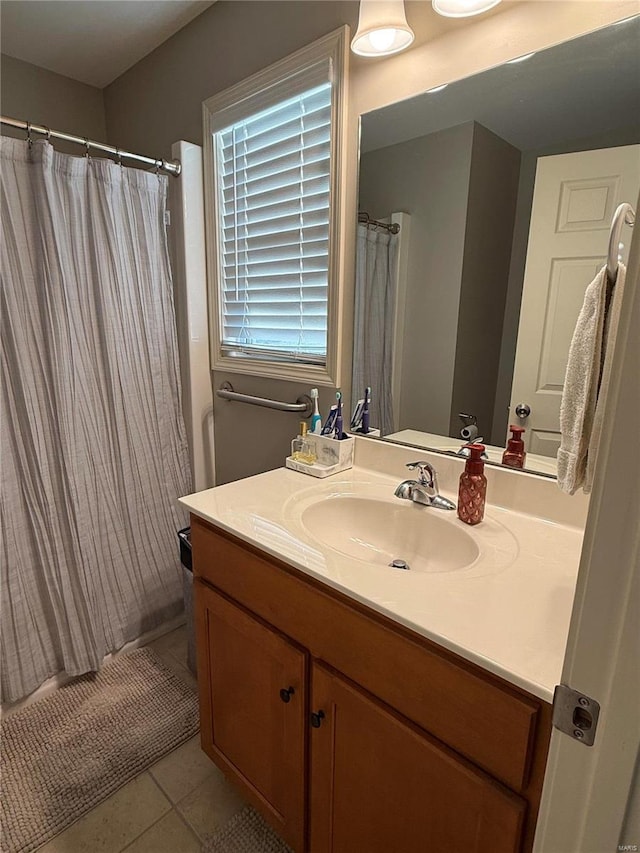 full bathroom featuring a shower with curtain, vanity, and tile patterned floors