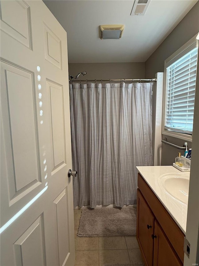 bathroom featuring vanity, curtained shower, tile patterned flooring, and visible vents