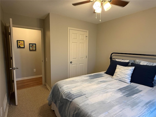 carpeted bedroom featuring ceiling fan and baseboards