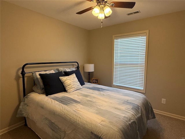 bedroom featuring carpet floors, baseboards, visible vents, and ceiling fan