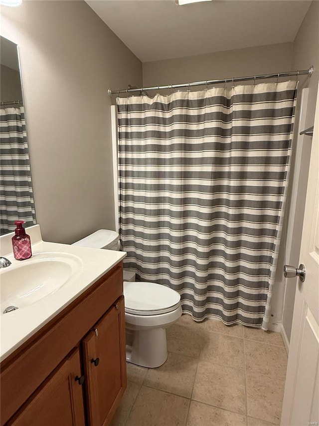 bathroom with tile patterned flooring, a shower with shower curtain, vanity, and toilet