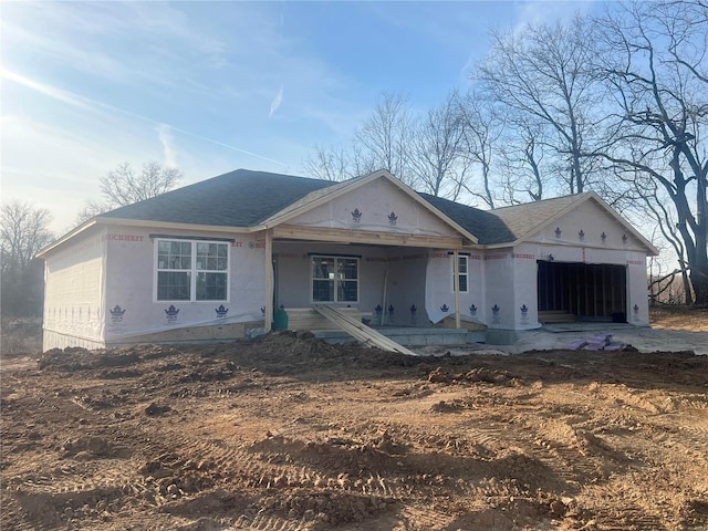 property under construction with an attached garage and a shingled roof