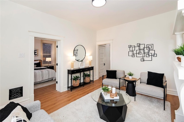 living room with baseboards and wood finished floors