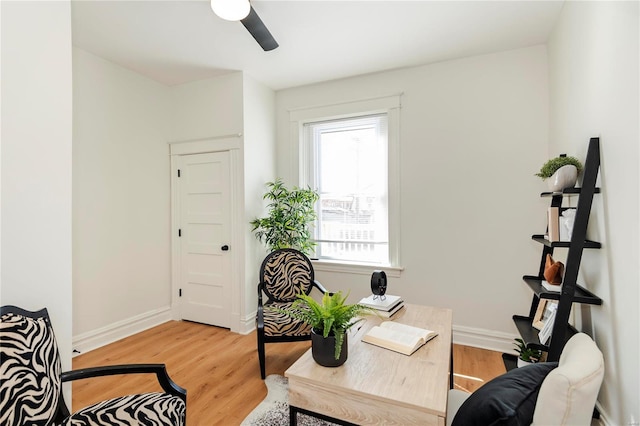 interior space with light wood-style floors, baseboards, and ceiling fan