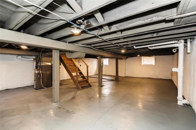 below grade area with stairs and heating unit