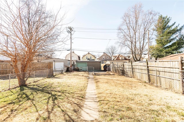 view of yard featuring an outbuilding and fence private yard