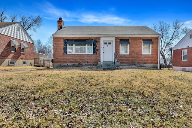 bungalow with brick siding, a chimney, and a front lawn