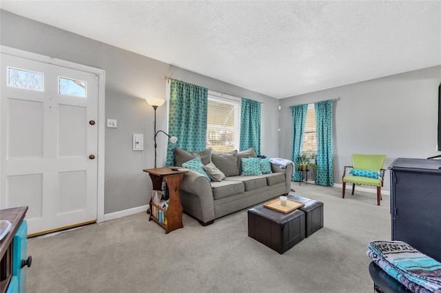 carpeted living area featuring a textured ceiling and baseboards