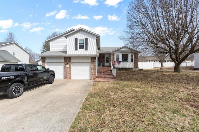 split level home featuring concrete driveway, roof with shingles, an attached garage, fence, and brick siding