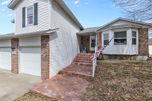 view of front of property with a garage, concrete driveway, and brick siding