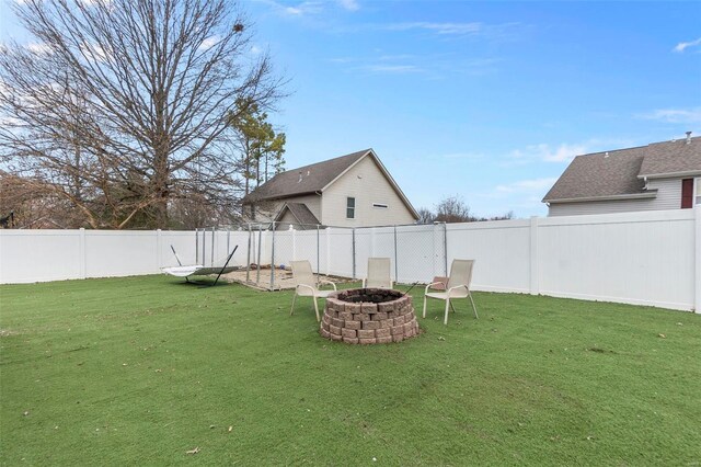 view of yard with an outdoor fire pit and a fenced backyard