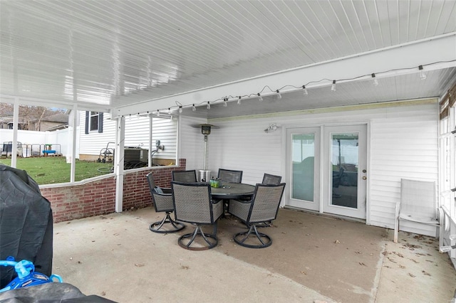 view of patio with outdoor dining area, grilling area, and fence