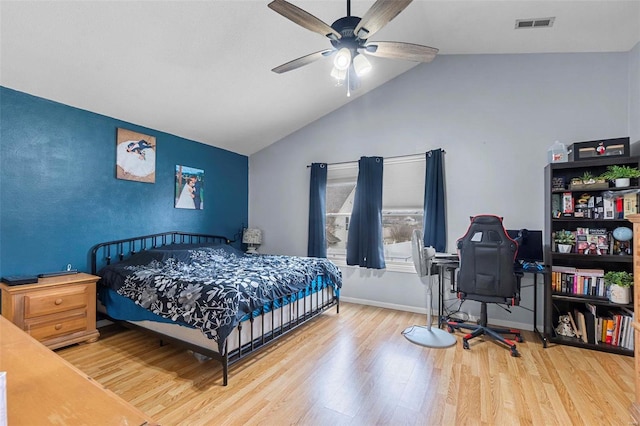 bedroom with visible vents, ceiling fan, vaulted ceiling, wood finished floors, and baseboards