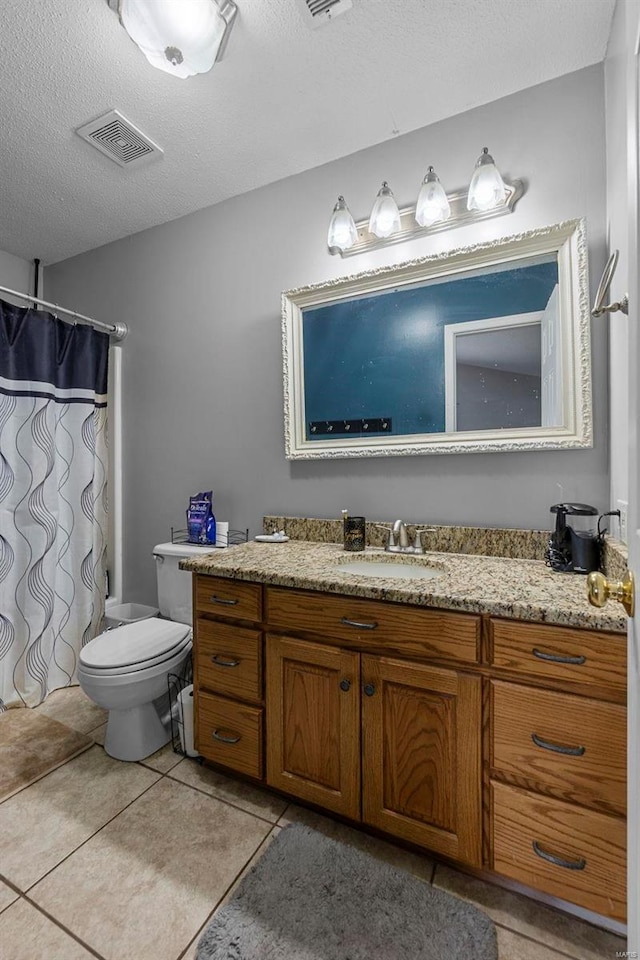 bathroom with visible vents, toilet, tile patterned floors, a textured ceiling, and vanity