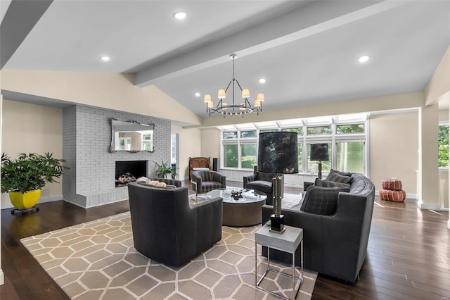 living room with vaulted ceiling with beams, recessed lighting, wood-type flooring, an inviting chandelier, and a brick fireplace