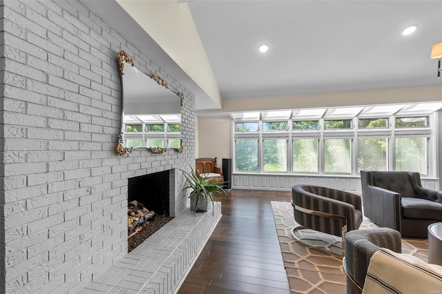 living room featuring dark wood-style floors, a wealth of natural light, a fireplace, and recessed lighting