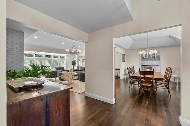 dining space with a chandelier, recessed lighting, dark wood finished floors, and baseboards