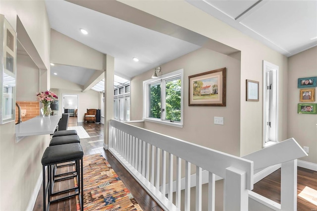 hall with lofted ceiling, dark wood-style flooring, baseboards, and recessed lighting