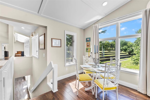 dining room featuring lofted ceiling, wood-type flooring, baseboards, and recessed lighting