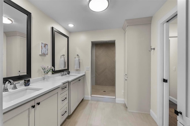 full bath featuring a sink, baseboards, and double vanity