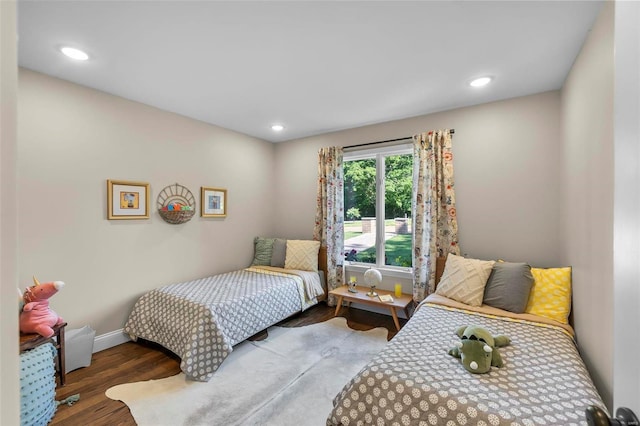 bedroom with recessed lighting, baseboards, and wood finished floors