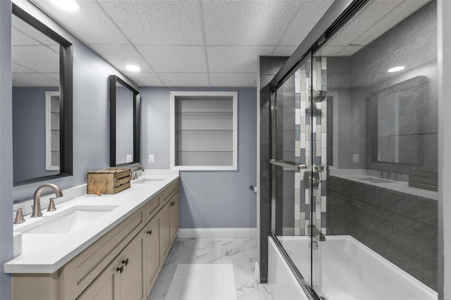 bathroom with marble finish floor, baseboards, an enclosed shower, and a sink