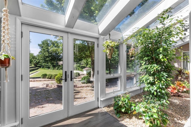 unfurnished sunroom featuring french doors and a skylight