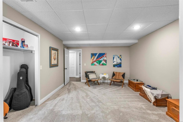 living area with carpet floors, baseboards, a paneled ceiling, and recessed lighting