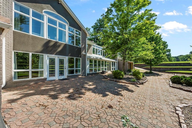 back of house featuring a patio and stucco siding