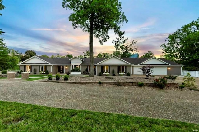 view of front of property featuring fence and an attached garage