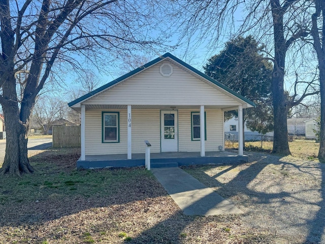 bungalow with a porch and fence