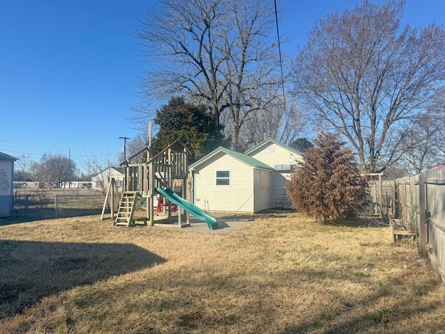 view of play area with a fenced backyard and a lawn