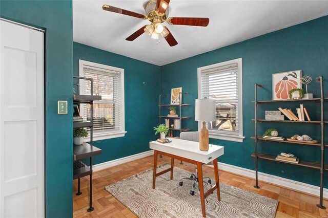 home office with a wealth of natural light, baseboards, and ceiling fan