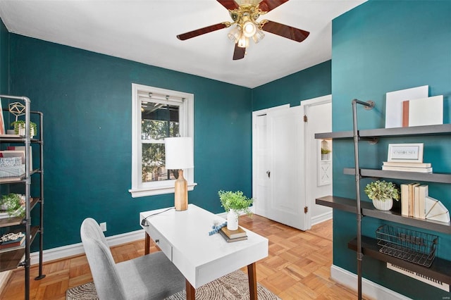 office area featuring baseboards and ceiling fan