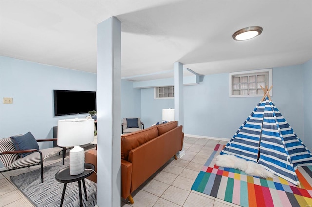 living area with light tile patterned floors and baseboards