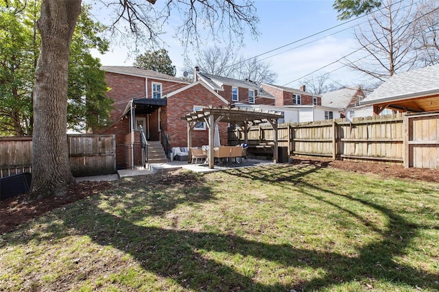 back of property featuring a fenced backyard, a pergola, a lawn, a patio area, and brick siding