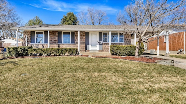 single story home featuring central air condition unit, a front lawn, and brick siding