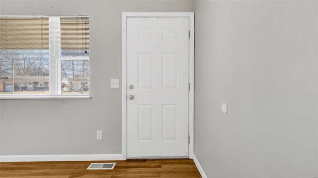 entryway featuring visible vents, baseboards, and wood finished floors