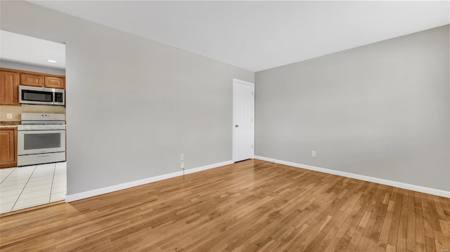 interior space with light wood-style flooring and baseboards