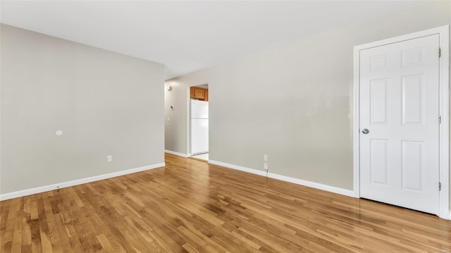 unfurnished room featuring light wood-type flooring and baseboards