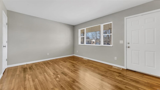 entrance foyer with visible vents, baseboards, and wood finished floors