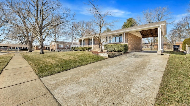 view of front facade with driveway, a carport, a front lawn, and brick siding