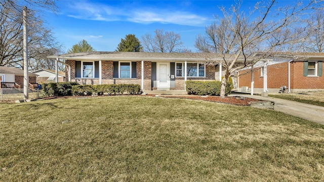 ranch-style house featuring fence, a front lawn, and brick siding