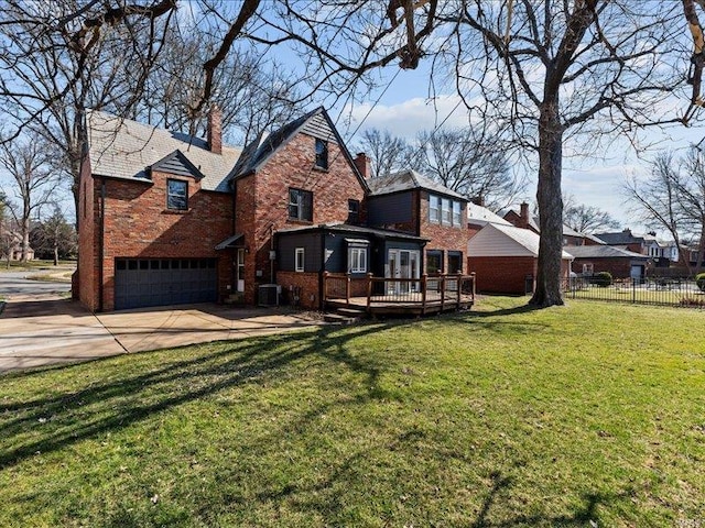 exterior space featuring brick siding, concrete driveway, an attached garage, a front yard, and fence