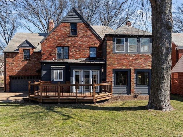 rear view of property featuring a deck, a yard, brick siding, and a chimney