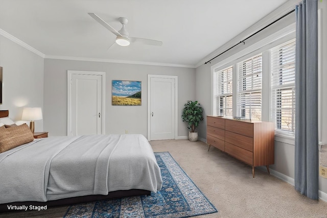 bedroom with crown molding, two closets, light colored carpet, a ceiling fan, and baseboards