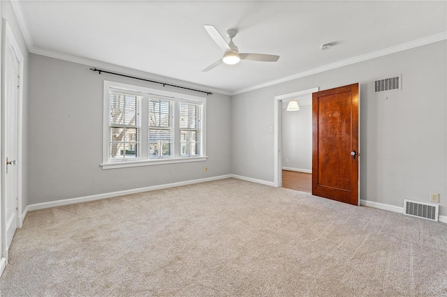 unfurnished bedroom featuring carpet, visible vents, and crown molding