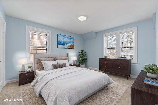 bedroom featuring light carpet and baseboards